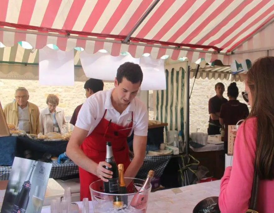 tom serving customer prosecco at the castle complex in oxford 