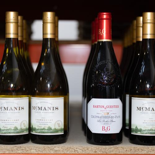 Bottles of red and white wine on a shelf in a warehouse 