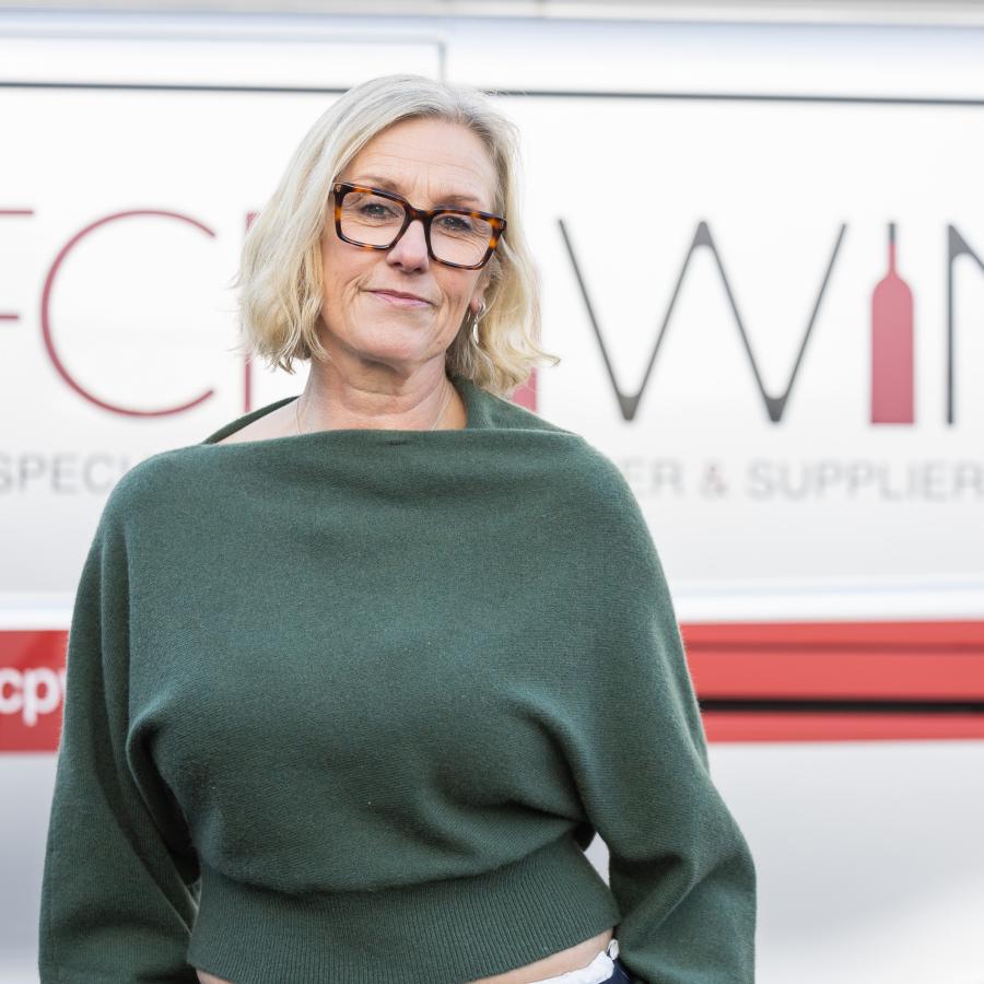 Tina Lewis standing by the company van 