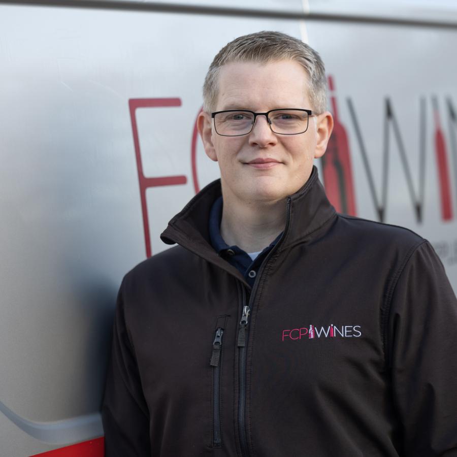 Rob Atkison standing by the company van 