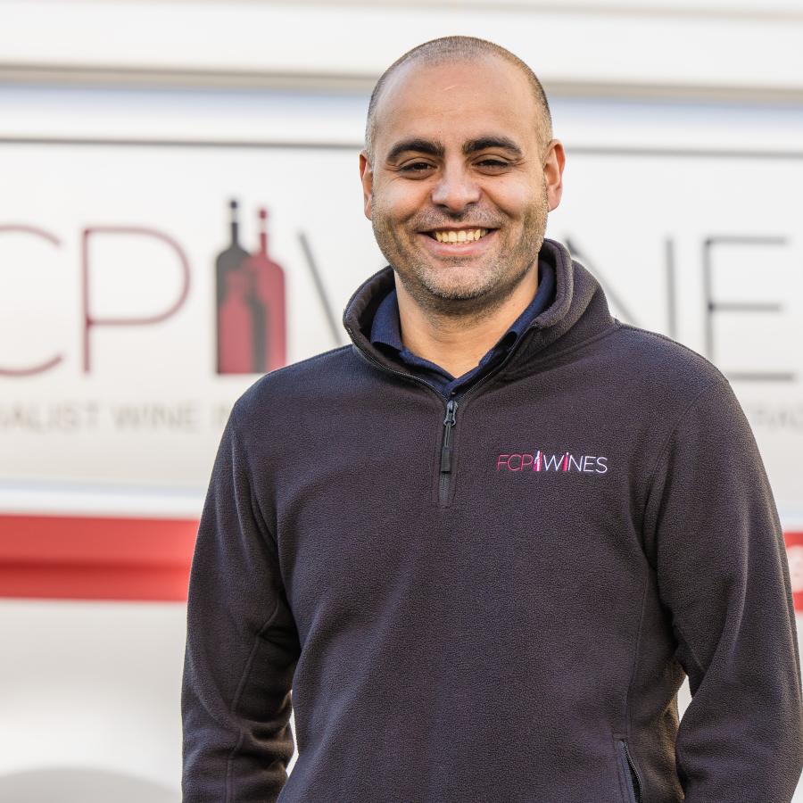 Marian standing by a van posing for photo