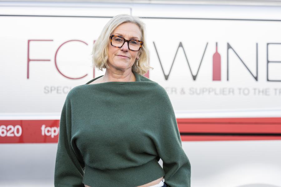 Tina Lewis standing by the company van 