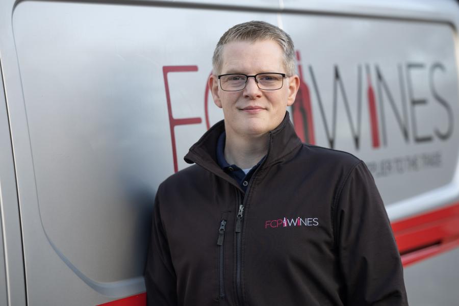 Rob Atkison standing by the company van 