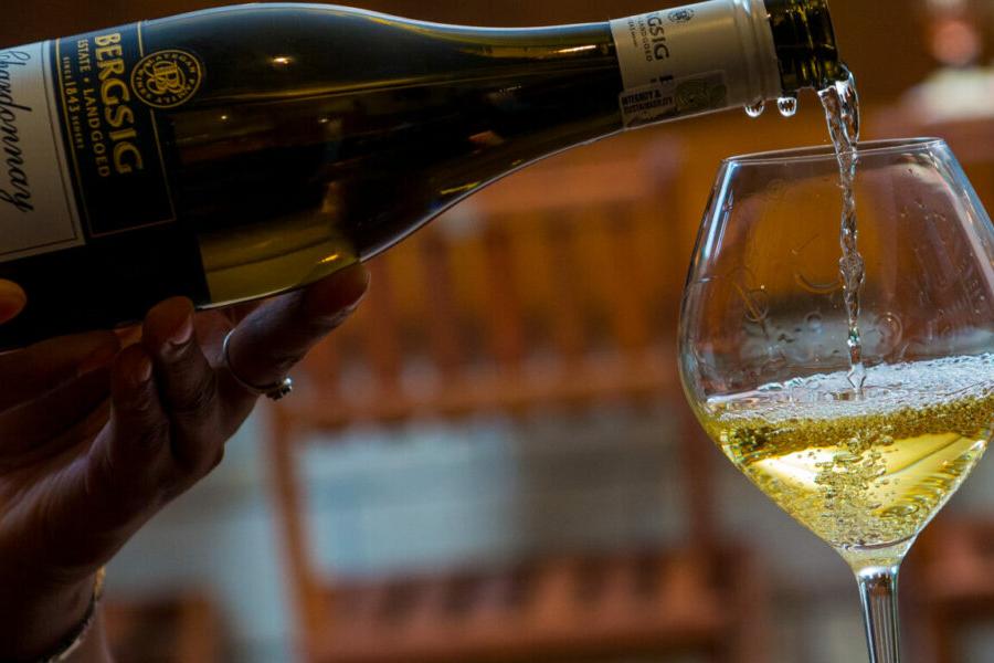 Bottle of wine pouring to a glass of wine