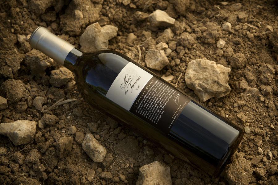 A bottle of wine on top of rocks