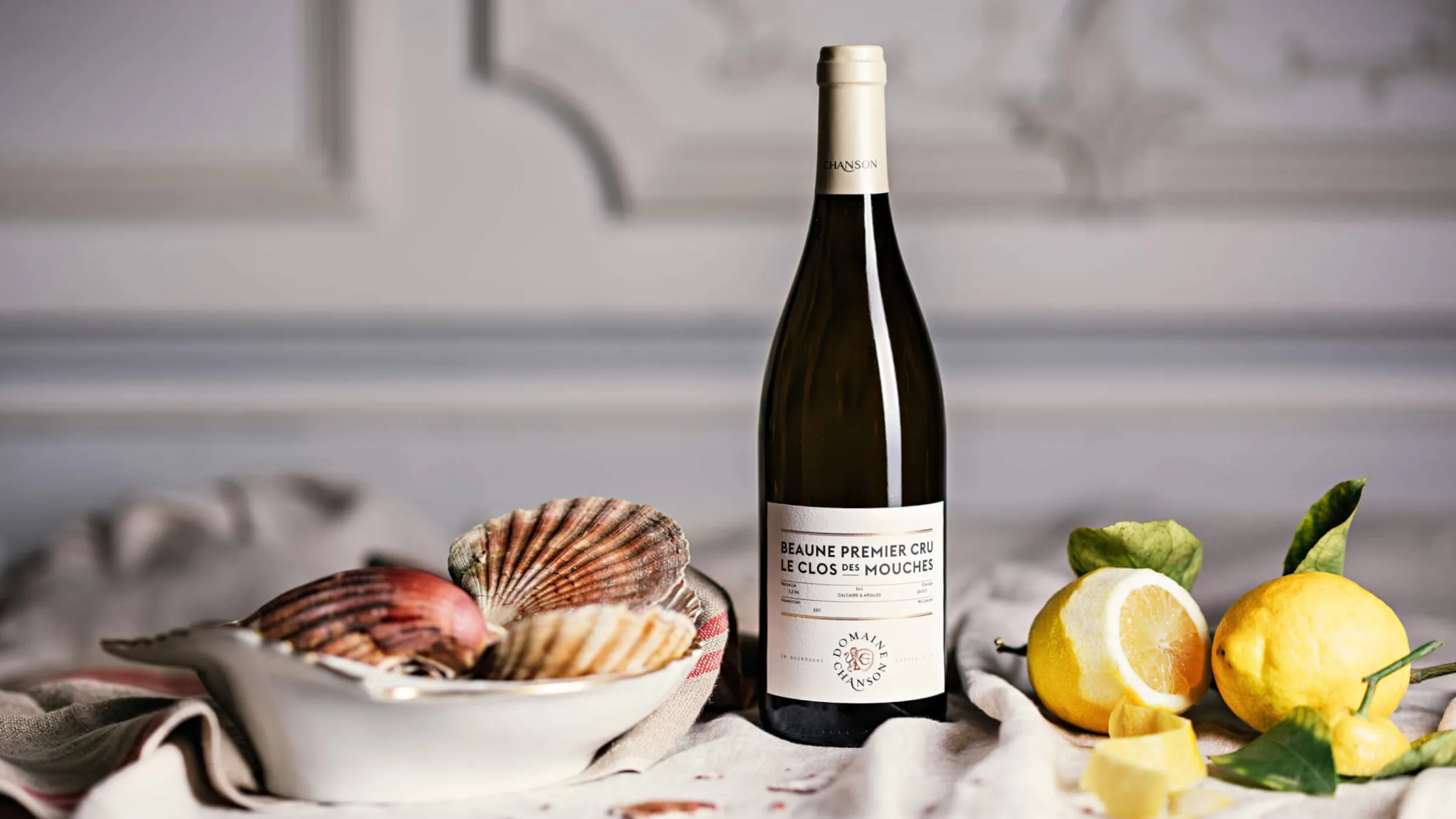 Bottle of wine with shells and limes