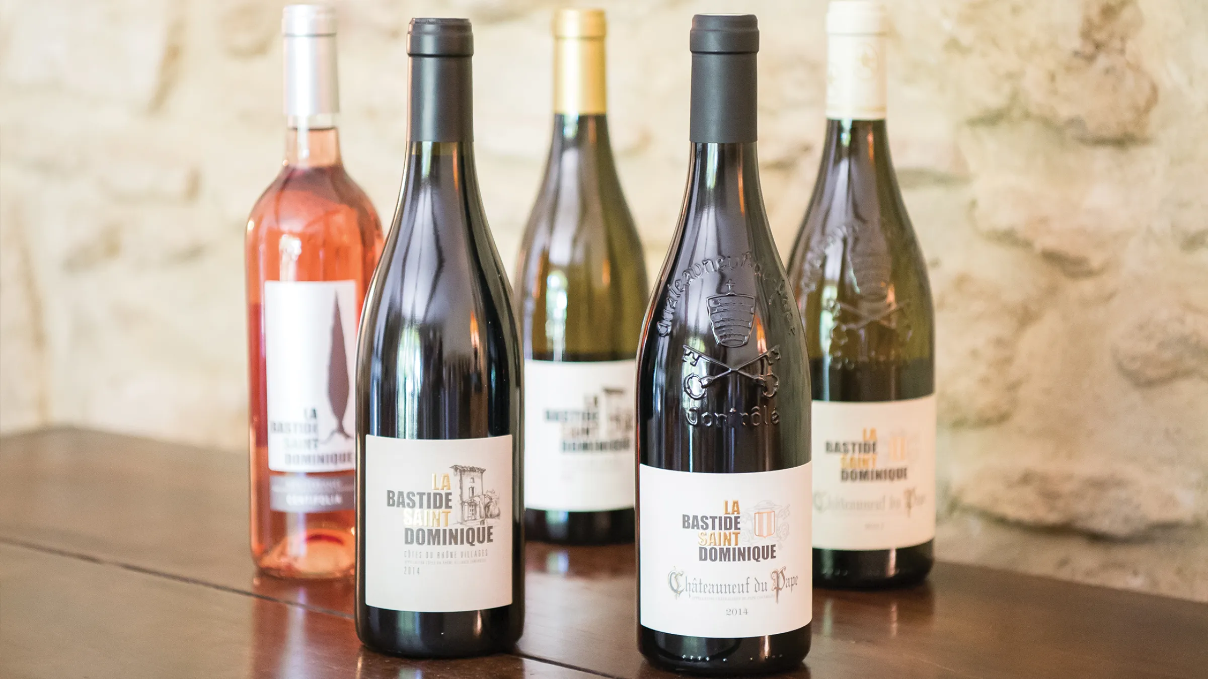 Bottles of different types of wine on top of a table
